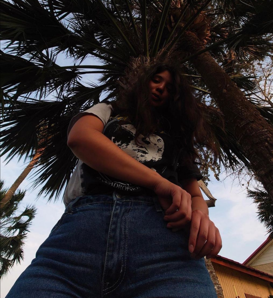 Posing under a palm tree