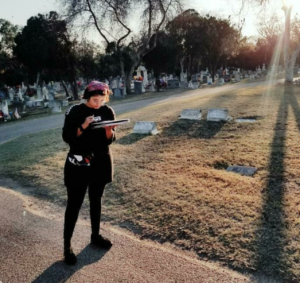 a photo of me scheduling some commercial spots in a cemetery.